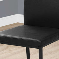 Two 38" Black Leather Look, Foam, and Metal Dining Chairs