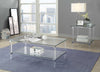 Metal Accented Glass Top Coffee Table with Open Shelf and Acrylic Legs, Silver and Clear