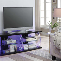Wooden TV Stand with Acrylic Posts and Four Open Compartments, Black and Clear