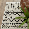 5’ x 7’ Ivory and Black Eclectic Patterns Indoor Area Rug