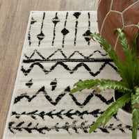 7’ x 9’ Ivory and Black Eclectic Patterns Indoor Area Rug